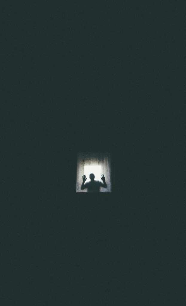 Her Shadow Stayed Behind Eerie silhouette of a person against a window, conveying themes of isolation and entrapment.