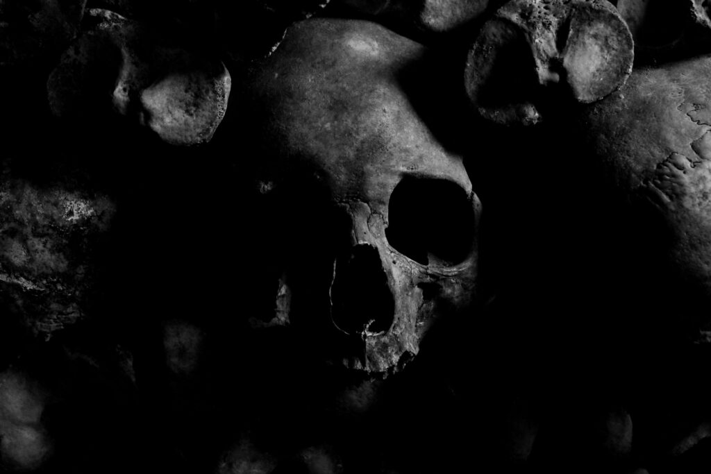 The Hinterkaifeck Murders Dark eerie skull image with a moody atmosphere from the Paris Catacombs.